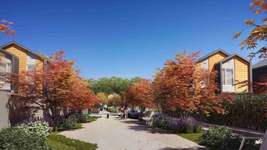Proyecto Absalón Casas de Arboleda del Maipo, hay un pequeño paseo con árboles y personas caminando