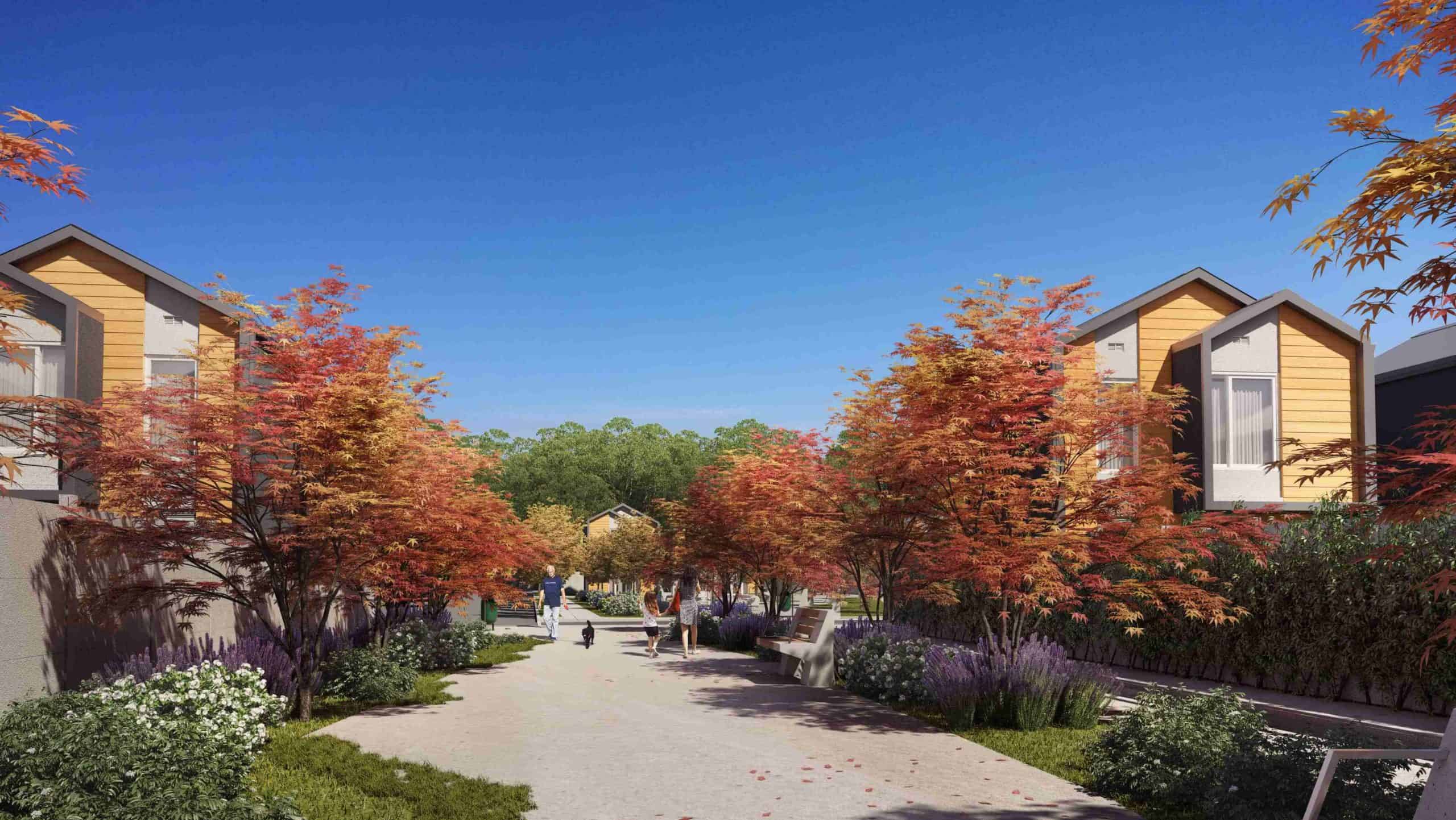 Proyecto Absalón Casas de Arboleda del Maipo, hay un pequeño paseo con árboles y personas caminando